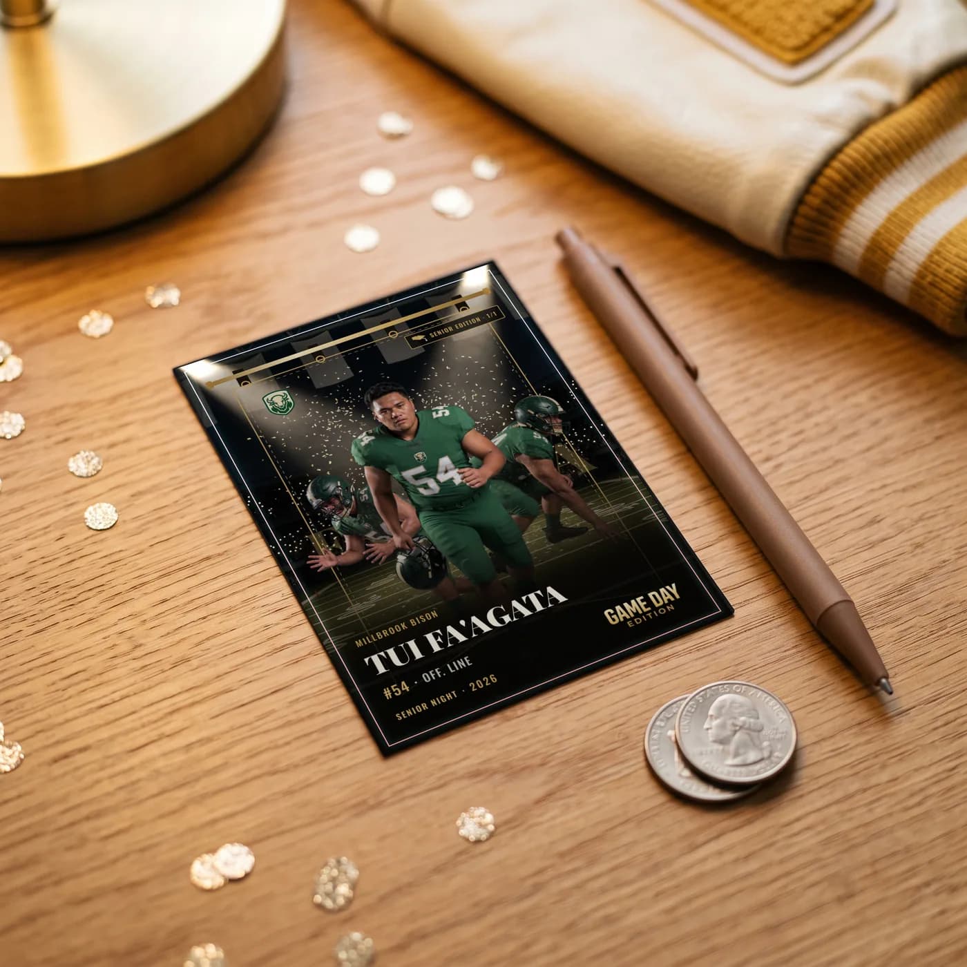 A custom football trading card lying on a wooden desk beside a pen and a coin, for scale — Senior Night finish — example artwork, fictional athlete; photo generated